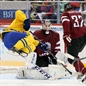 SOCHI, RUSSIA - FEBRUARY 15: Sweden's Daniel Sedin #22 goes airborne as Latvia's Arturs Kulda #32 trips him in front of the net as Kristers Gudlevskis #50 defends during men's preliminary round action at the Sochi 2014 Olympic Winter Games. (Photo by Andre Ringuette/HHOF-IIHF Images)
